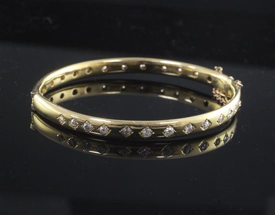 A modern gold and diamond hinged bangle,